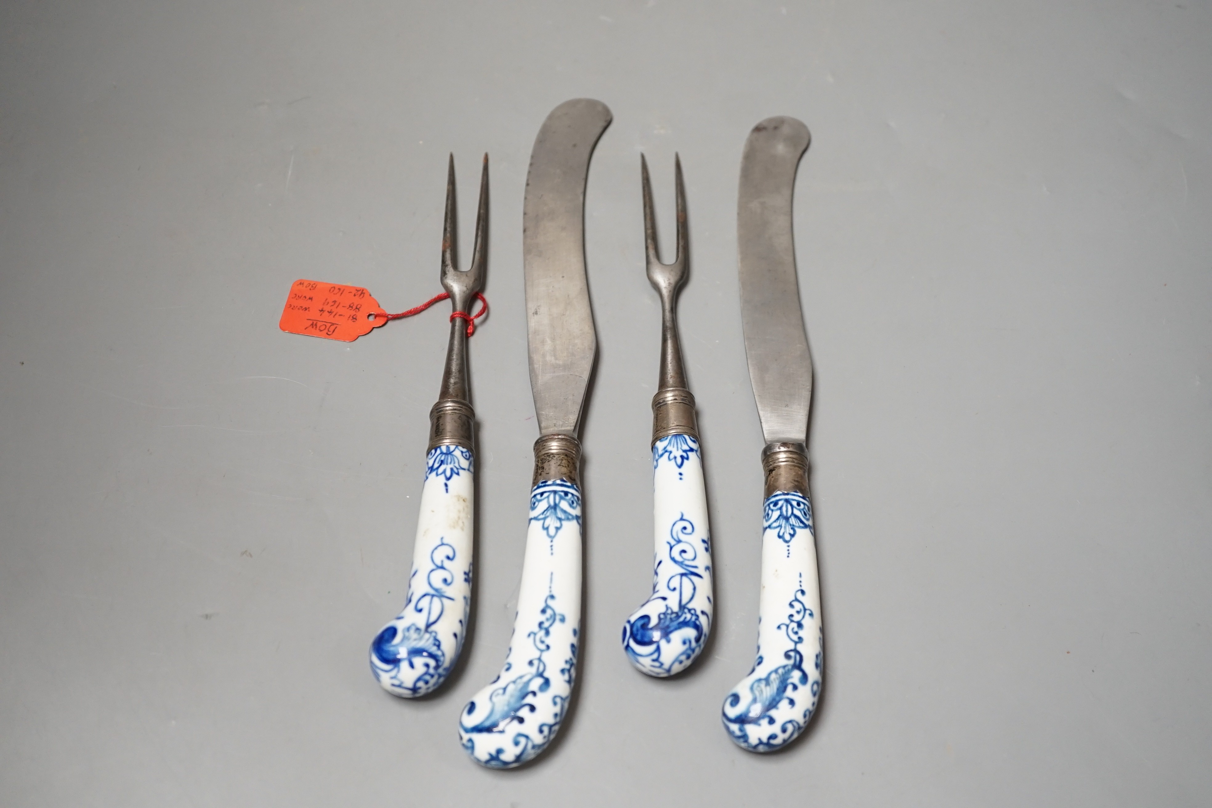 Two pairs of Bow blue and white pistol grip steel carving knives and forks, c.1755, longest night of 28cm